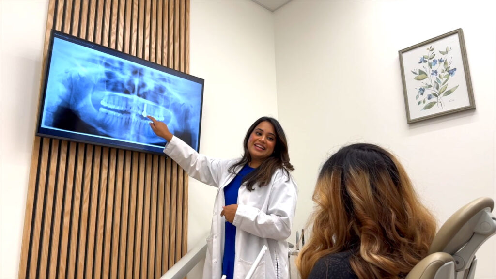 Smile Circle Dental doctor explaining a dental X-ray to a patient in a modern, bright operatory with wood panel accents